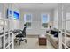 Bright home office featuring white wainscoting, large windows, a desk, and a comfortable seating area at 1182 Welcome Dr Dr, Mount Pleasant, SC 29464