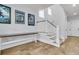 Elegant staircase with white railings and wooden treads leads to the upper level with natural light from transom windows at 1182 Welcome Dr Dr, Mount Pleasant, SC 29464