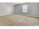 Bright, carpeted bedroom with neutral walls, a window, and ample natural light at 121 Ancestry Ln, Moncks Corner, SC 29461