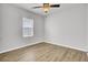 Bright bedroom with natural light, featuring wood-look floors and a window with blinds at 121 Ancestry Ln, Moncks Corner, SC 29461