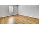 Well-lit bedroom with hardwood floors and a bright window offering neighborhood views at 121 Ancestry Ln, Moncks Corner, SC 29461