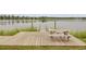 Inviting wooden dock extending over calm lake waters, complete with a picnic table for serene moments at 121 Ancestry Ln, Moncks Corner, SC 29461