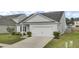 Well-maintained single-Gathering home showcasing a driveway leading to a two-car attached garage at 121 Ancestry Ln, Moncks Corner, SC 29461