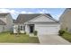 Charming single-story home with a well-manicured lawn and attached two-car garage at 121 Ancestry Ln, Moncks Corner, SC 29461