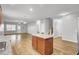 Open-concept living room and kitchen with hardwood floors and neutral color palette at 121 Ancestry Ln, Moncks Corner, SC 29461