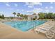 A pristine community pool with palm trees, lounge chairs, and a pool house for ultimate relaxation at 121 Ancestry Ln, Moncks Corner, SC 29461
