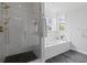 Bathroom features a walk-in glass shower with gold fixtures and a luxurious soaking tub at 1216 Rivers Reach Dr, Charleston, SC 29492