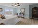 Sunlit bedroom boasts plank floors, pale blue walls, a large window and wood furniture at 1216 Rivers Reach Dr, Charleston, SC 29492