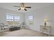 Bright bedroom with decorative chairs, end table, and two windows with outdoor views at 1216 Rivers Reach Dr, Charleston, SC 29492