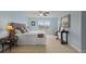 Bright bedroom with blue walls, a woven headboard, plank floors, and a large window at 1216 Rivers Reach Dr, Charleston, SC 29492