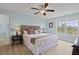 Inviting bedroom with plank floors, blue walls, a woven headboard, and a large window at 1216 Rivers Reach Dr, Charleston, SC 29492