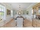 Bright dining room with hardwood floors, wainscoting, an elegant chandelier, and tasteful decor at 1216 Rivers Reach Dr, Charleston, SC 29492