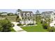 Beautiful home featuring a manicured lawn, palm trees and a charming front porch at 1216 Rivers Reach Dr, Charleston, SC 29492