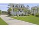 Charming yellow two-story home with a porch, landscaped yard, and a long driveway at 1216 Rivers Reach Dr, Charleston, SC 29492