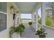 Inviting covered front porch with lovely view and gray stained floors and white pillars at 1216 Rivers Reach Dr, Charleston, SC 29492