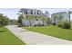 Inviting two-story home featuring a spacious lawn, elevated design, and welcoming front porch perfect for relaxing outdoors at 1216 Rivers Reach Dr, Charleston, SC 29492