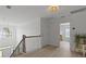 Upstairs hallway featuring hardwood floors, decorative lighting and an open staircase at 1216 Rivers Reach Dr, Charleston, SC 29492