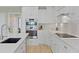 Well-lit kitchen with white cabinets, stainless steel appliances, stone backsplash, and hard wood floors at 1216 Rivers Reach Dr, Charleston, SC 29492