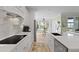 Bright kitchen with white cabinets, stainless steel appliances, quartz countertops, and an adjacent dining area at 1216 Rivers Reach Dr, Charleston, SC 29492