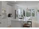 Bright white kitchen with an island, stainless steel appliances, hardwood floors, and an eat-in breakfast nook at 1216 Rivers Reach Dr, Charleston, SC 29492
