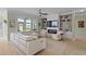 Bright living room boasts custom built-ins surrounding a fireplace and large windows overlooking a beautiful view at 1216 Rivers Reach Dr, Charleston, SC 29492