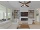 Bright living room boasts custom built-ins surrounding a fireplace and large windows overlooking a beautiful view at 1216 Rivers Reach Dr, Charleston, SC 29492