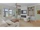 Bright living room boasts custom built-ins surrounding a fireplace and large windows overlooking a beautiful view at 1216 Rivers Reach Dr, Charleston, SC 29492
