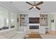 Bright living room featuring hard wood floors, built-in shelving, and a cozy fireplace at 1216 Rivers Reach Dr, Charleston, SC 29492