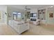 Bright living room featuring a fireplace, built-in shelving and entertainment center, and a white leather sofa at 1216 Rivers Reach Dr, Charleston, SC 29492