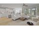Open-concept living area with a modern kitchen, light wood floors, and large windows offering ample natural light at 1216 Rivers Reach Dr, Charleston, SC 29492