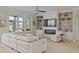 Bright living room boasts custom built-ins surrounding a fireplace and large windows overlooking a beautiful view at 1216 Rivers Reach Dr, Charleston, SC 29492