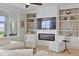 Cozy living room features built-in shelves, a fireplace, and comfortable seating at 1216 Rivers Reach Dr, Charleston, SC 29492