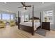 Bright bedroom boasts a four-poster bed, wood floors, ample natural light, and scenic water views at 1216 Rivers Reach Dr, Charleston, SC 29492
