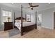 Bright bedroom features a four-poster bed, wood floors, a ceiling fan, and plenty of natural light at 1216 Rivers Reach Dr, Charleston, SC 29492