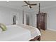 Bright bedroom showcasing a four-poster bed, wood floors, and easy access to the bathroom and other rooms at 1216 Rivers Reach Dr, Charleston, SC 29492