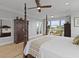 Charming bedroom with water view featuring a four-poster bed, wood floors, and a tranquil sitting area at 1216 Rivers Reach Dr, Charleston, SC 29492