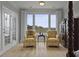 Charming sitting area with scenic views, French doors, comfortable chairs, and beautiful wood floors at 1216 Rivers Reach Dr, Charleston, SC 29492