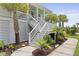 Staircase to a raised house with beautiful greenery and landscaping on either side at 1216 Rivers Reach Dr, Charleston, SC 29492