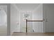 Well-lit stairwell with chandelier, wood railing, and white trim at 1216 Rivers Reach Dr, Charleston, SC 29492