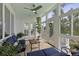 Beautiful sunroom with multiple windows, a ceiling fan, blue furniture, and indoor plants at 1216 Rivers Reach Dr, Charleston, SC 29492