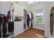 This walk-in closet has built-in shelving, drawers and a window bringing in natural light at 1216 Rivers Reach Dr, Charleston, SC 29492