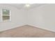 Cozy carpeted bedroom with ample natural light from the large window at 1240 Fairmont Ave # 22, Mount Pleasant, SC 29464