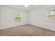 Sunlit bedroom features two windows and plush carpeting at 1240 Fairmont Ave # 22, Mount Pleasant, SC 29464