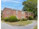 Two-story brick home with manicured landscaping and sidewalk leading to the front door at 1240 Fairmont Ave # 22, Mount Pleasant, SC 29464