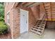 Charming exterior view of home #22, with brick facade and wooden stairs with black railings at 1240 Fairmont Ave # 22, Mount Pleasant, SC 29464