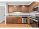 Kitchen with stainless steel appliances, wood cabinets, granite countertops, and stylish backsplash at 1240 Fairmont Ave # 22, Mount Pleasant, SC 29464