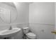 Bright half bathroom featuring a pedestal sink, oval mirror, and white fixtures at 125 Greyson Cir, Goose Creek, SC 29445