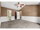 Spacious bedroom features paneled walls, neutral carpet, and views into the bathroom and closet at 125 Greyson Cir, Goose Creek, SC 29445