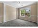 Neutral bedroom featuring large window providing a view of the surrounding neighborhood at 125 Greyson Cir, Goose Creek, SC 29445