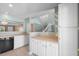 Bright kitchen boasts white cabinets, neutral countertops, and seamless flow into the living area at 125 Greyson Cir, Goose Creek, SC 29445